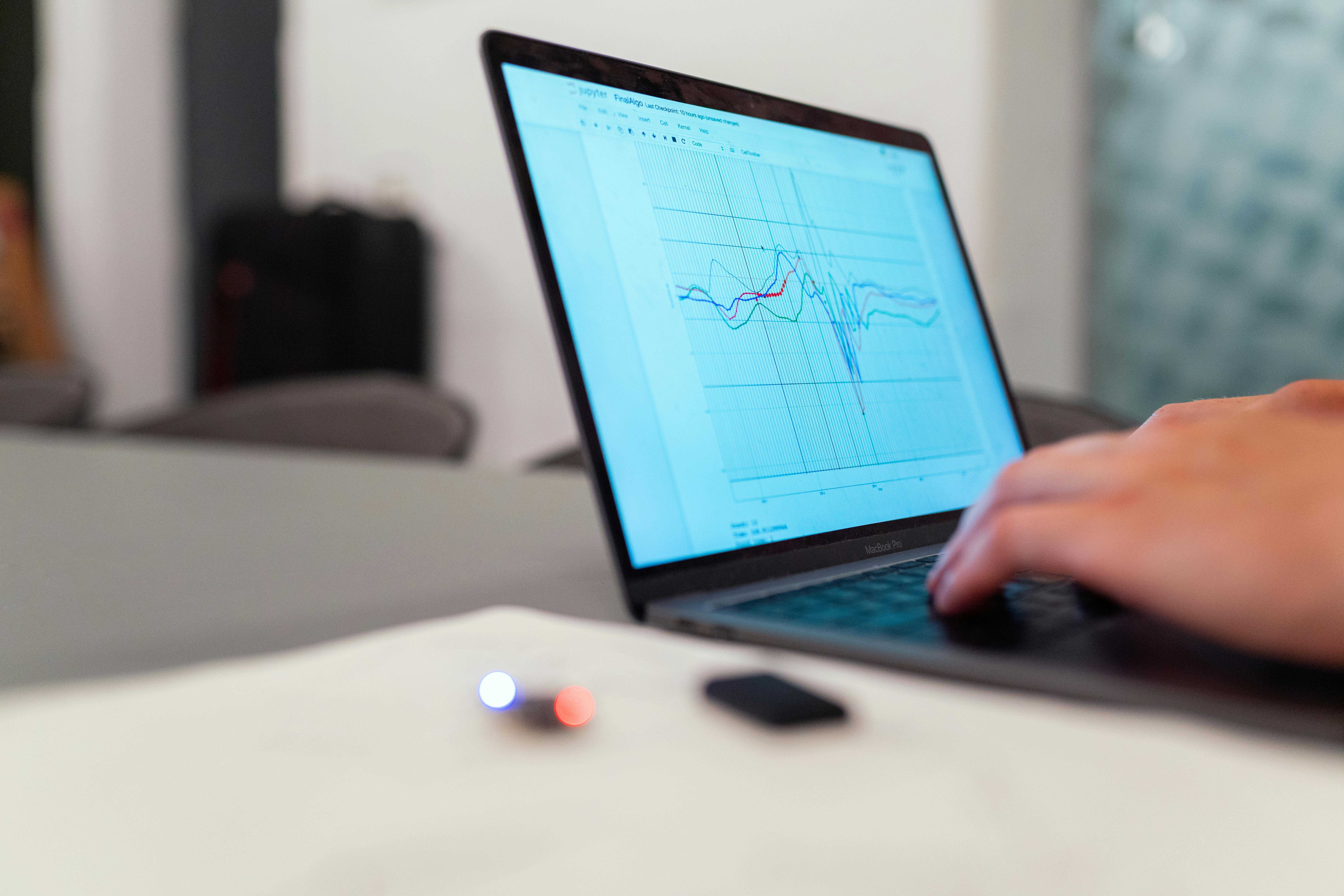Team collaborating around a table with laptops during a business meeting